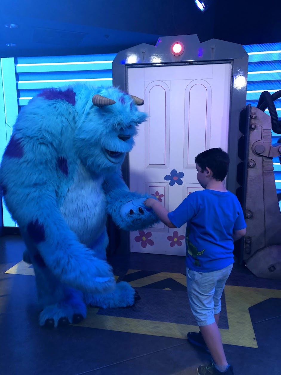 Giving Sully at high five at his character meet and greet in Hollywood Studios. 