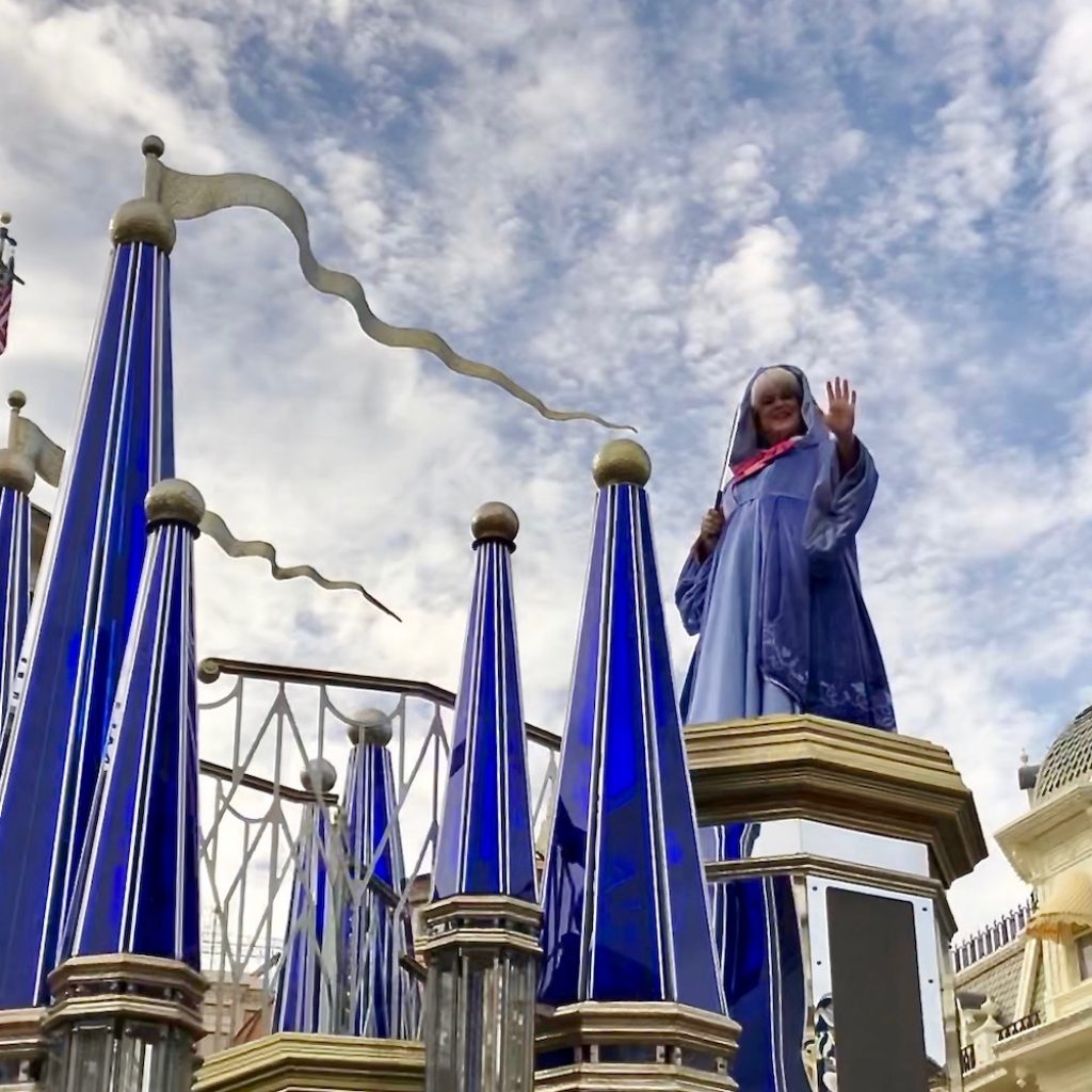 Fairy Godmother waving as part of the princess cavalcade in Magic Kingdom. 