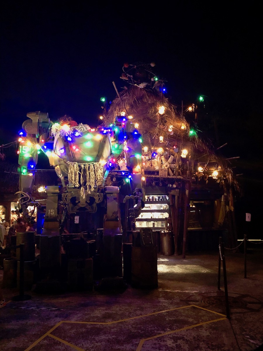 The giant robot and Pongu Pongu are decorated for Christmas in bright lights, Santa's hat, menorahs, and nutcrackers!