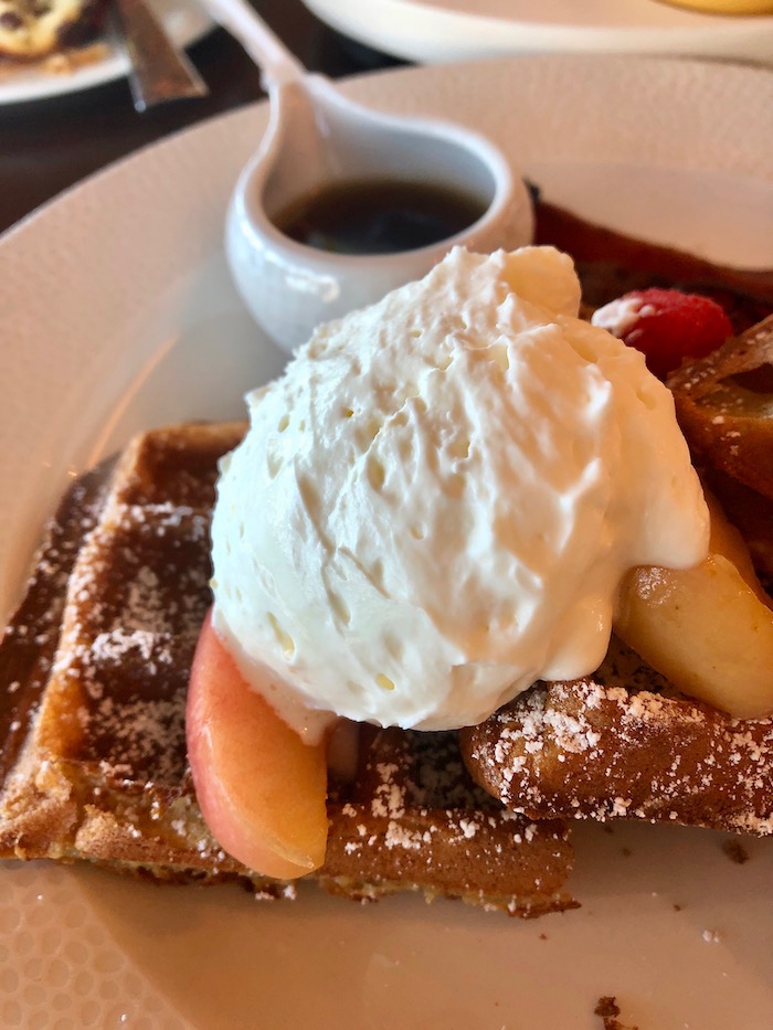 Sour cream waffle with chantilly, roasted apples and orange-maple syrup from Topolino's Terrace.